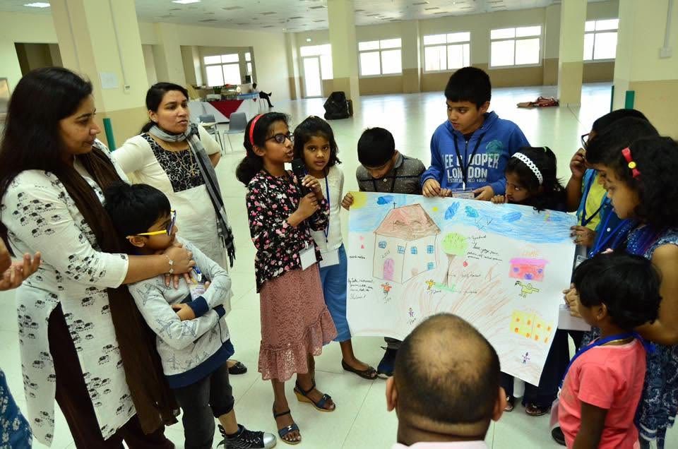 Children presenting a group activity poster at Sunday School